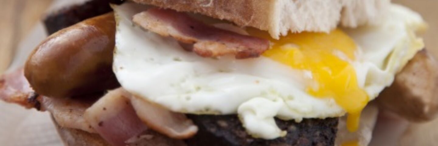 Simple sausage, bacon and egg sandwich