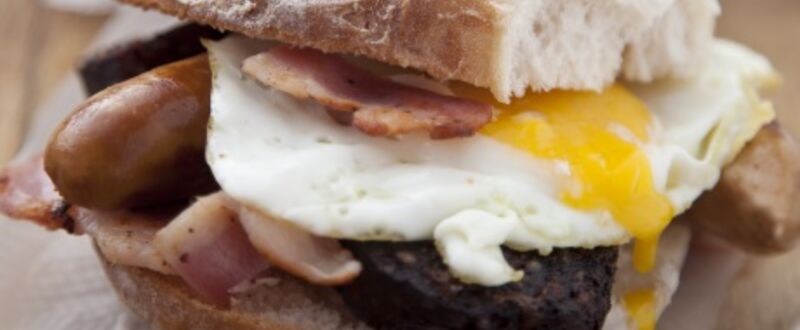 Simple sausage, bacon and egg sandwich