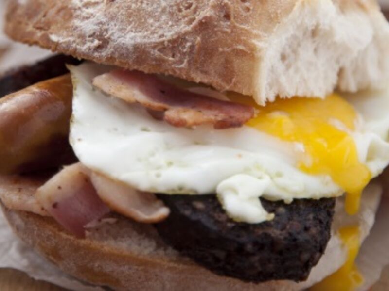 Simple sausage, bacon and egg sandwich