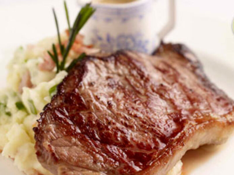 Striploin Steaks on Smoked Bacon Champ